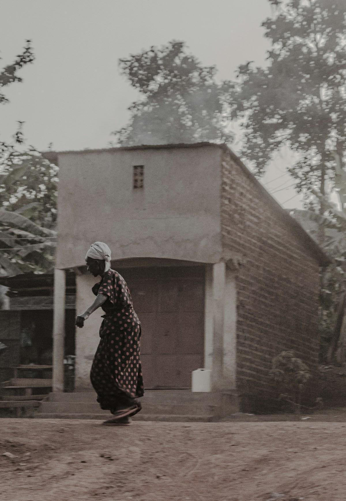 A woman walking through her community in Kampala, Uganda